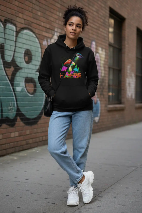 Woman wearing TAKE ME HIGHER hoodie in urban setting